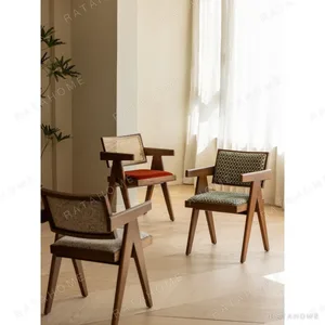 V-Leg Teak Armchair with Cane Back and Cushioned Seat in clay — in a room setting