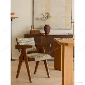 V-Leg Teak Armchair with Cane Back and Cushioned Seat in clay — in a room setting