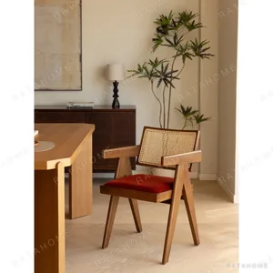 V-Leg Teak Armchair with Cane Back and Cushioned Seat in clay — in a room setting