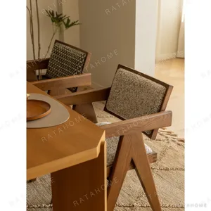 V-Leg Teak Armchair with Cane Back and Cushioned Seat in clay — in a room setting