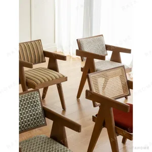 V-Leg Teak Armchair with Cane Back and Cushioned Seat in clay — in a room setting