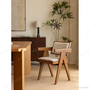 V-Leg Teak Armchair with Cane Back and Cushioned Seat in clay — in a room setting