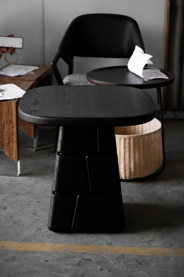 Charred Black Oak Low Table with Stacked Block Pedestal in black — in a room setting