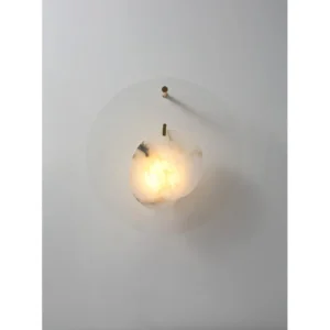 Clear Glass Disc Wall Light with Marbled Globe in silver — in a room setting