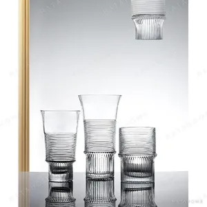 Clear Ribbed Glass Vases with Flared Rim, Small in ivory — in a room setting