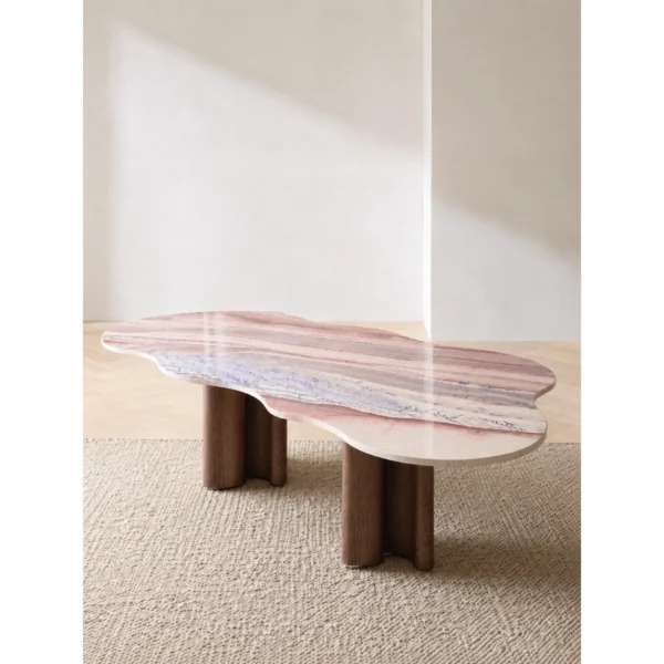 Cloud-Shaped Pink Marble Desk with Walnut Column Legs in rose stone — in a room setting