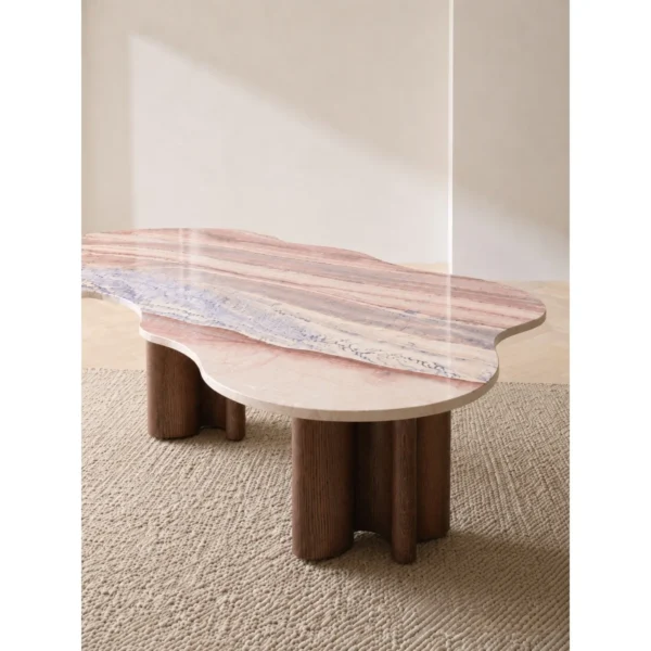 Cloud-Shaped Pink Marble Desk with Walnut Column Legs in rose stone — in a room setting
