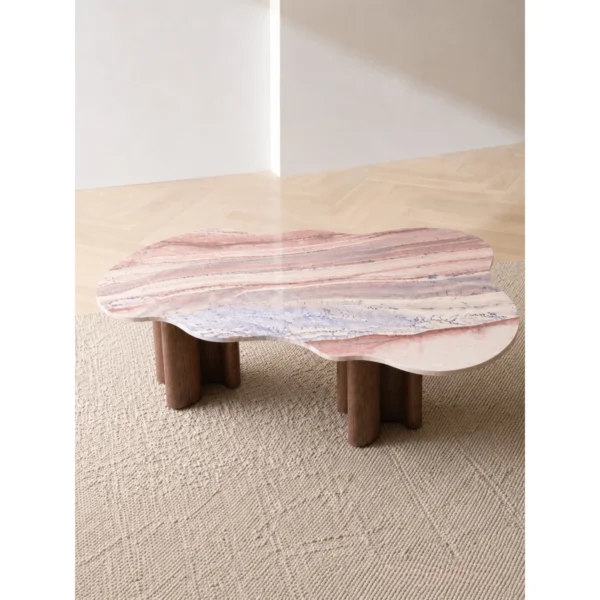 Cloud-Shaped Pink Marble Desk with Walnut Column Legs in rose stone — in a room setting