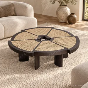 Round Rattan Segment Coffee Table in sand — in a room setting