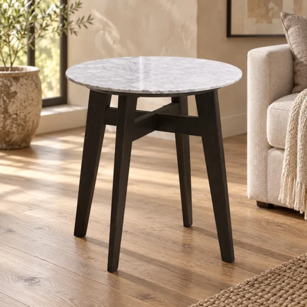 Round White Marble Side Table on Black Wood Tripod in ivory — in a room setting