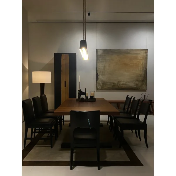 Colonie Black Brushed Oak Dining Table on Trestle Base in black — in a room setting