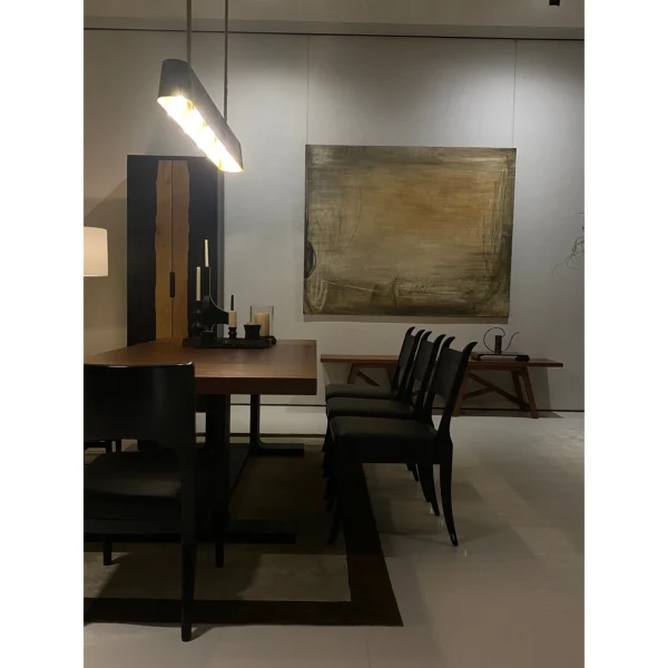 Colonie Black Brushed Oak Dining Table on Trestle Base in black — in a room setting