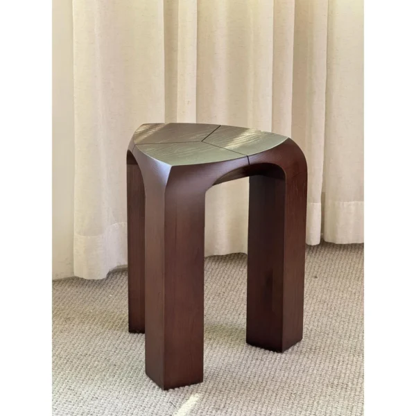 Dark Wood Arched Stool Side Table in walnut — in a room setting