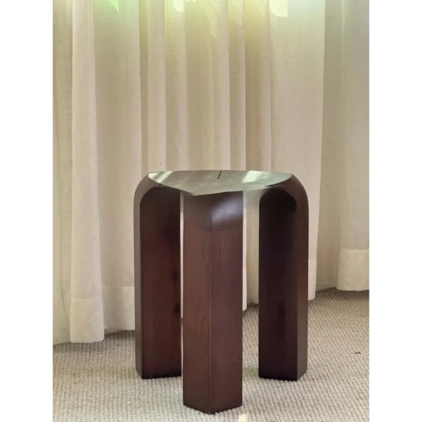 Dark Wood Arched Stool Side Table in walnut — in a room setting