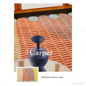 Colourful Linear Woven Rug with Bobble Edges in mustard — in a room setting