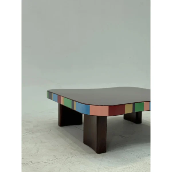 Colourful Striped Edge Mid-Century Coffee Table in black — in a room setting