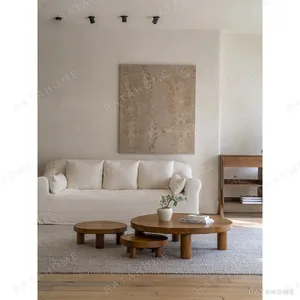 Teak Round Coffee Table Set of 3 on Cylinder Legs in natural oak — in a room setting