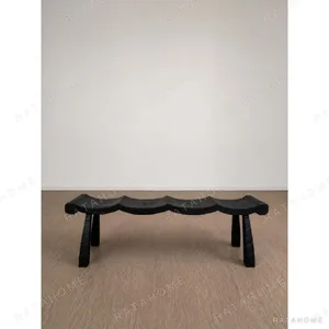 Contour Wave Bench in Charred Black Wood — in a room setting