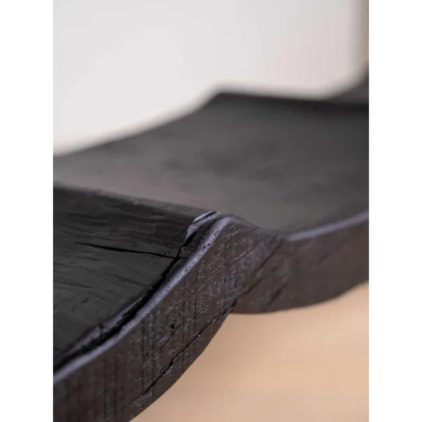 Contour Wave Bench in Charred Black Wood — in a room setting