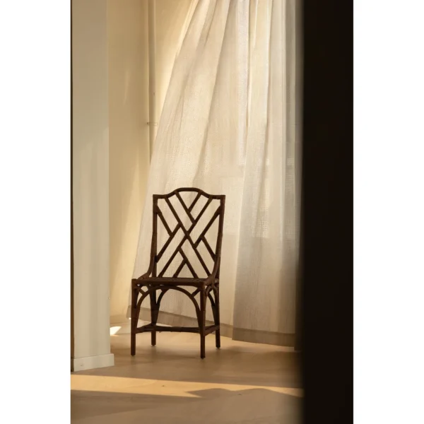 Dark Rattan Fretwork Side Chair in clay — in a room setting