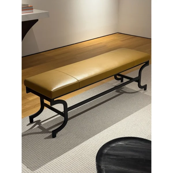 Curved Bronze Leg Bench with Caramel Leather Seat in clay — in a room setting