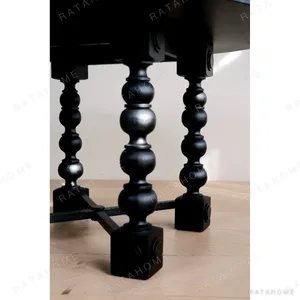 Courtyard Black Round Table on Hand-Carved Column Legs in black — in a room setting