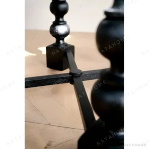 Courtyard Black Round Table on Hand-Carved Column Legs in black — in a room setting