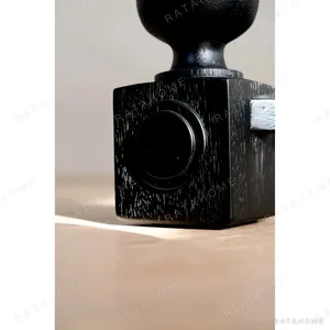 Courtyard Black Round Table on Hand-Carved Column Legs in black — in a room setting