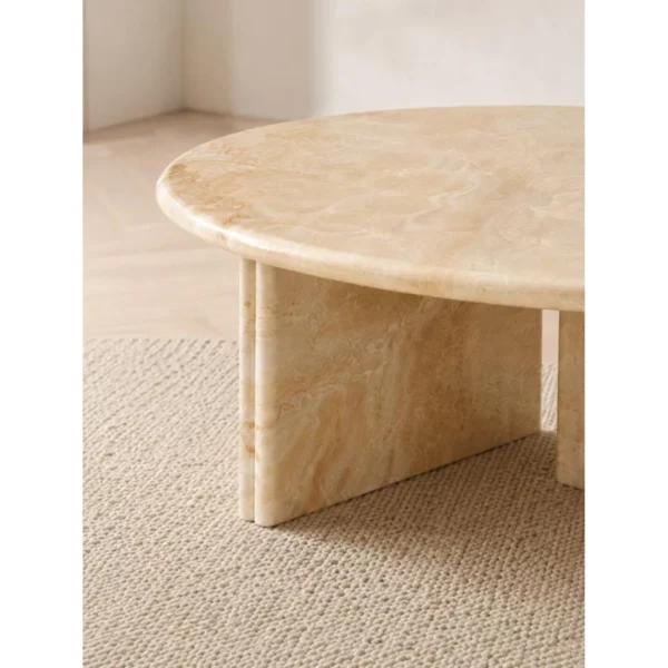 Cream Onyx Round Coffee Table on Cross Stone Base in oatmeal — in a room setting