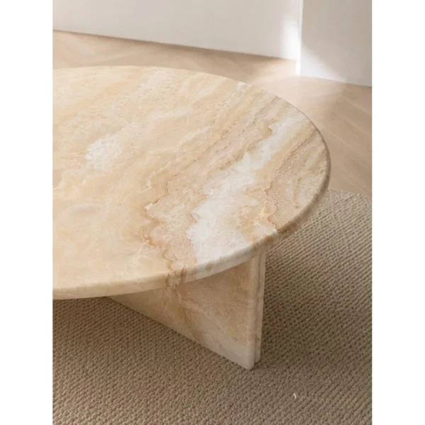 Cream Onyx Round Coffee Table on Cross Stone Base in oatmeal — in a room setting
