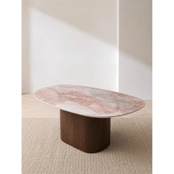 Pink-Grey Marble Oval Dining Table on Fluted Dark Wood Base in rose stone — in a room setting