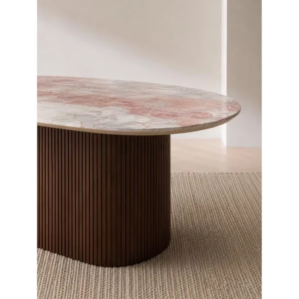 Pink-Grey Marble Oval Dining Table on Fluted Dark Wood Base in rose stone — in a room setting