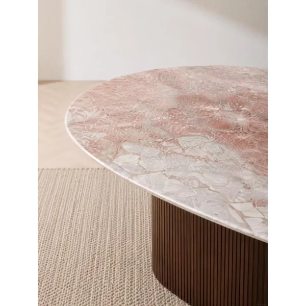 Pink-Grey Marble Oval Dining Table on Fluted Dark Wood Base in rose stone — in a room setting
