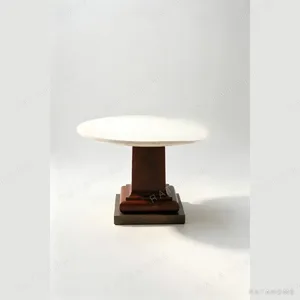 Cream Travertine Round Table in oatmeal — in a room setting