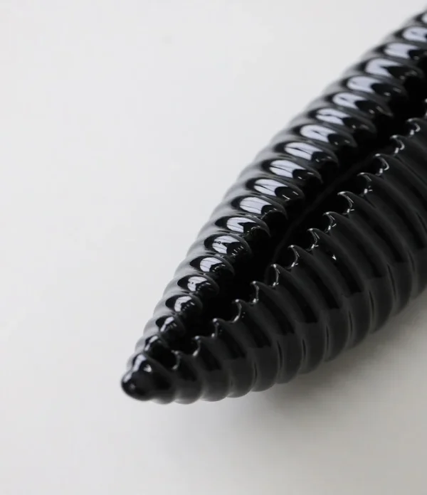 Glossy Black Ribbed Boat Bowl Ornament, Small in black — in a room setting
