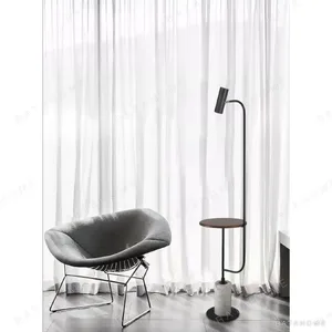 Curved Arm Floor Lamp with Walnut Tray and Marble Base in black — in a room setting