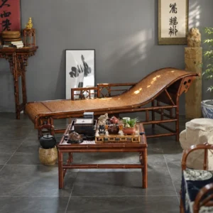 Curved Bamboo and Woven Cane Chaise Lounge in black — in a room setting