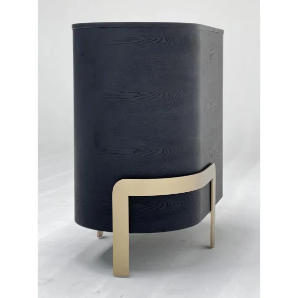 Curved Black Ash Three-Drawer Chest on Champagne Base in black — in a room setting