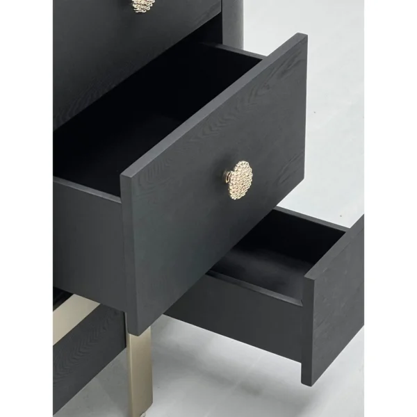 Curved Black Ash Three-Drawer Chest on Champagne Base in black — in a room setting