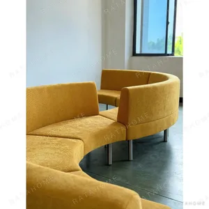 Curved Serpentine Sofa in mustard — in a room setting