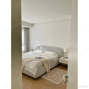 Curved Cotton-Linen Bed with Inset Mattress Frame in sand — in a room setting