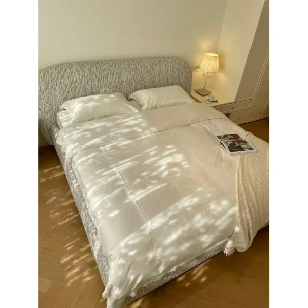 Curved Cotton-Linen Bed with Inset Mattress Frame in sand — in a room setting