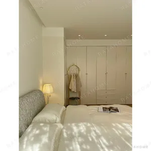 Curved Cotton-Linen Bed with Inset Mattress Frame in sand — in a room setting
