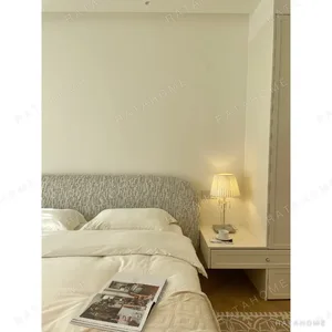 Curved Cotton-Linen Bed with Inset Mattress Frame in sand — in a room setting