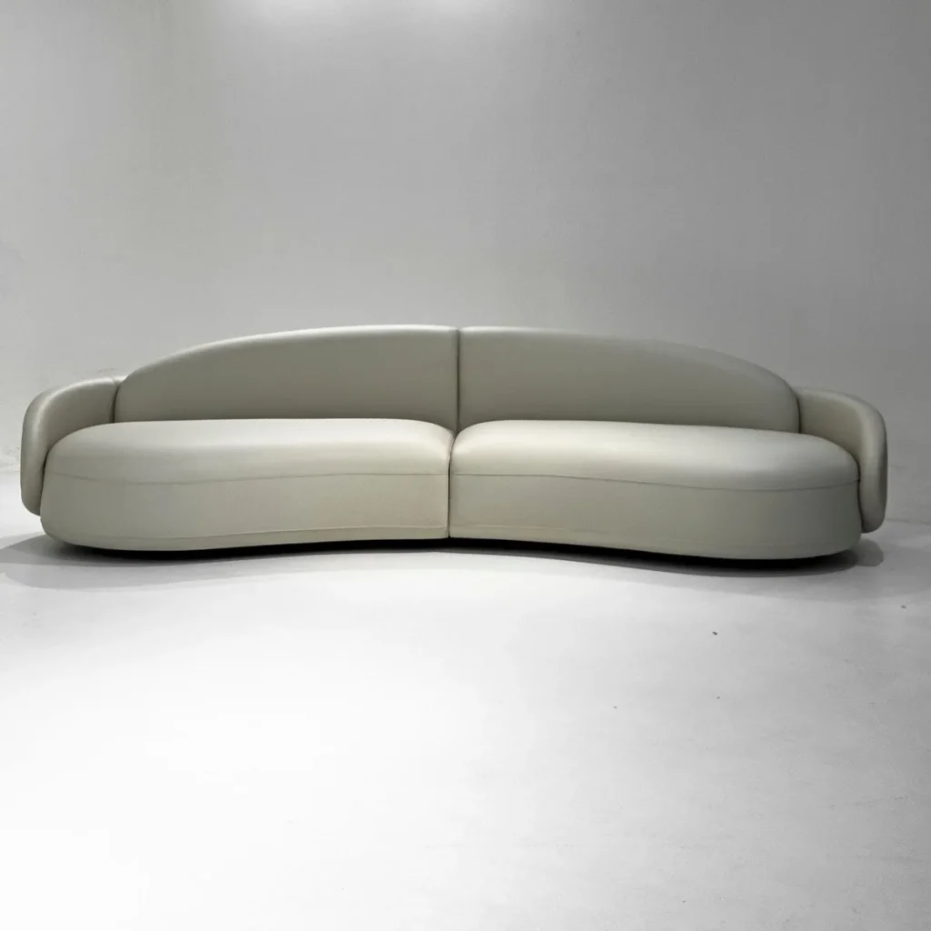 Curved Sofa in Sage Leather and Fabric with Handmade Seams — front view