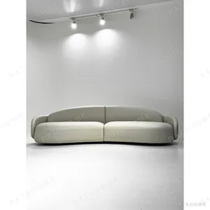Curved Sofa in Sage Leather and Fabric with Handmade Seams — in a room setting