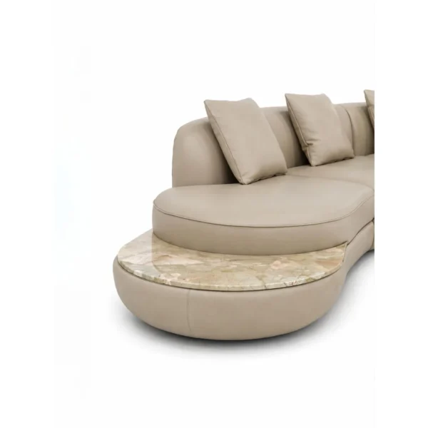 Curved Sofa in Cream Fabric with Natural Stone Side Ledge — in a room setting
