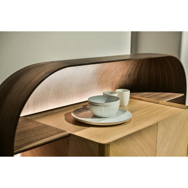 Curved Oak Bar Cabinet with Integrated Light Strip in natural oak — in a room setting
