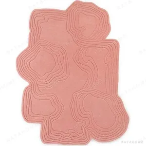 Custom Blush Contour Relief Rug with Wavy Edge in rose stone — in a room setting