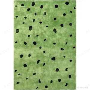 Custom Green Rug with Scattered Black Spots in olive — in a room setting